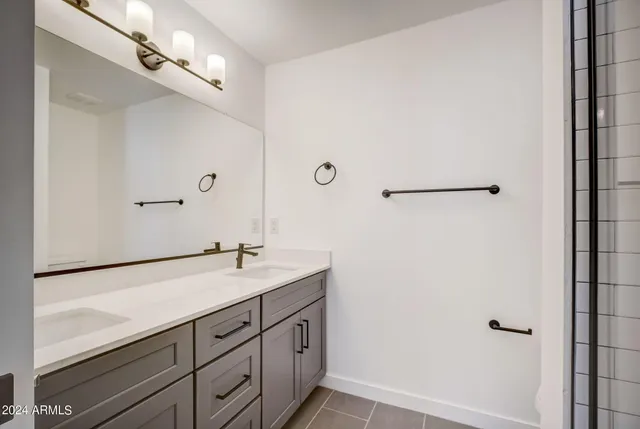 a bathroom with a sink a mirror and bathtub