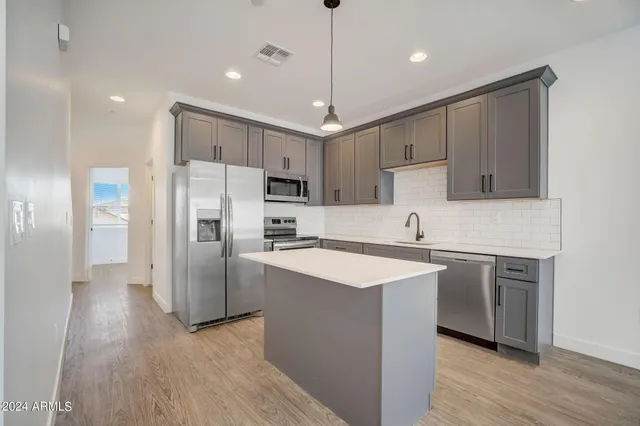 a kitchen with a stove a sink and a refrigerator