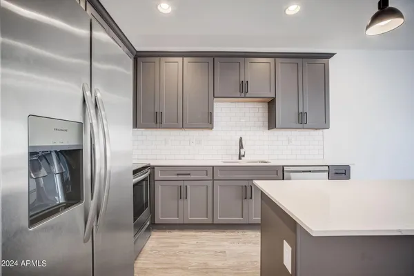 a kitchen with a stove and a sink