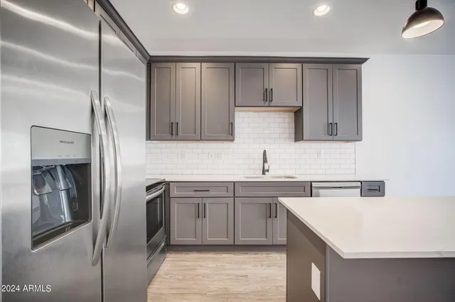 a kitchen with a stove and a sink