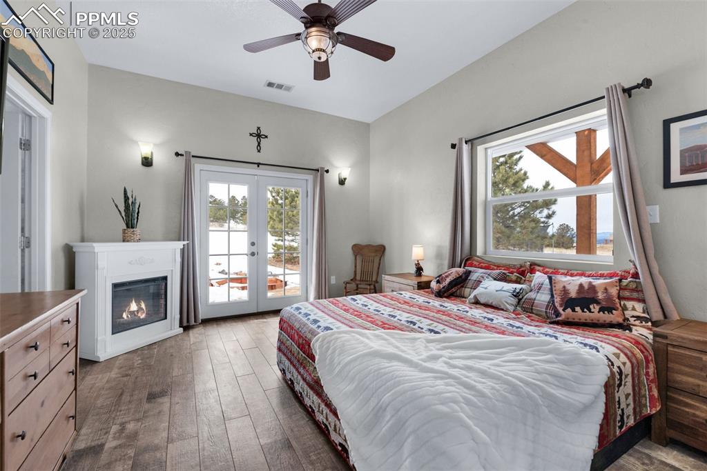 311 Knickerbocker Road Silver Cliff, CO 81252 - Photo 13 of 50 a bedroom with a bed flat screen tv and a large window
