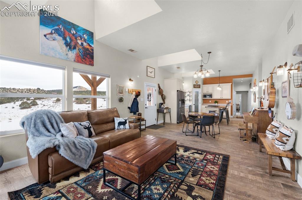 311 Knickerbocker Road Silver Cliff, CO 81252 - Photo 8 of 50 a living room with furniture large window and a table