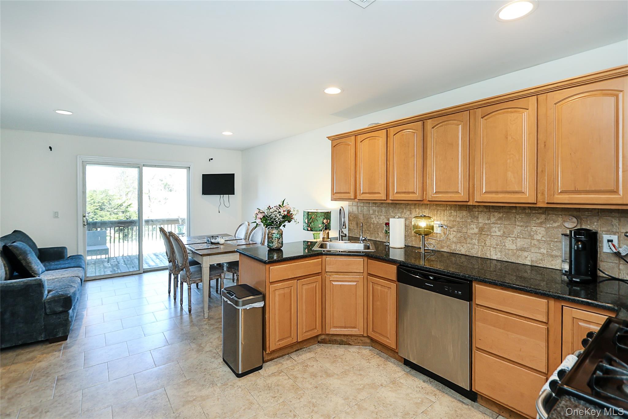 54 Landing Road Glen Cove, NY 11542 - Photo 11 of 24 a kitchen with stainless steel appliances granite countertop sink window and dining table
