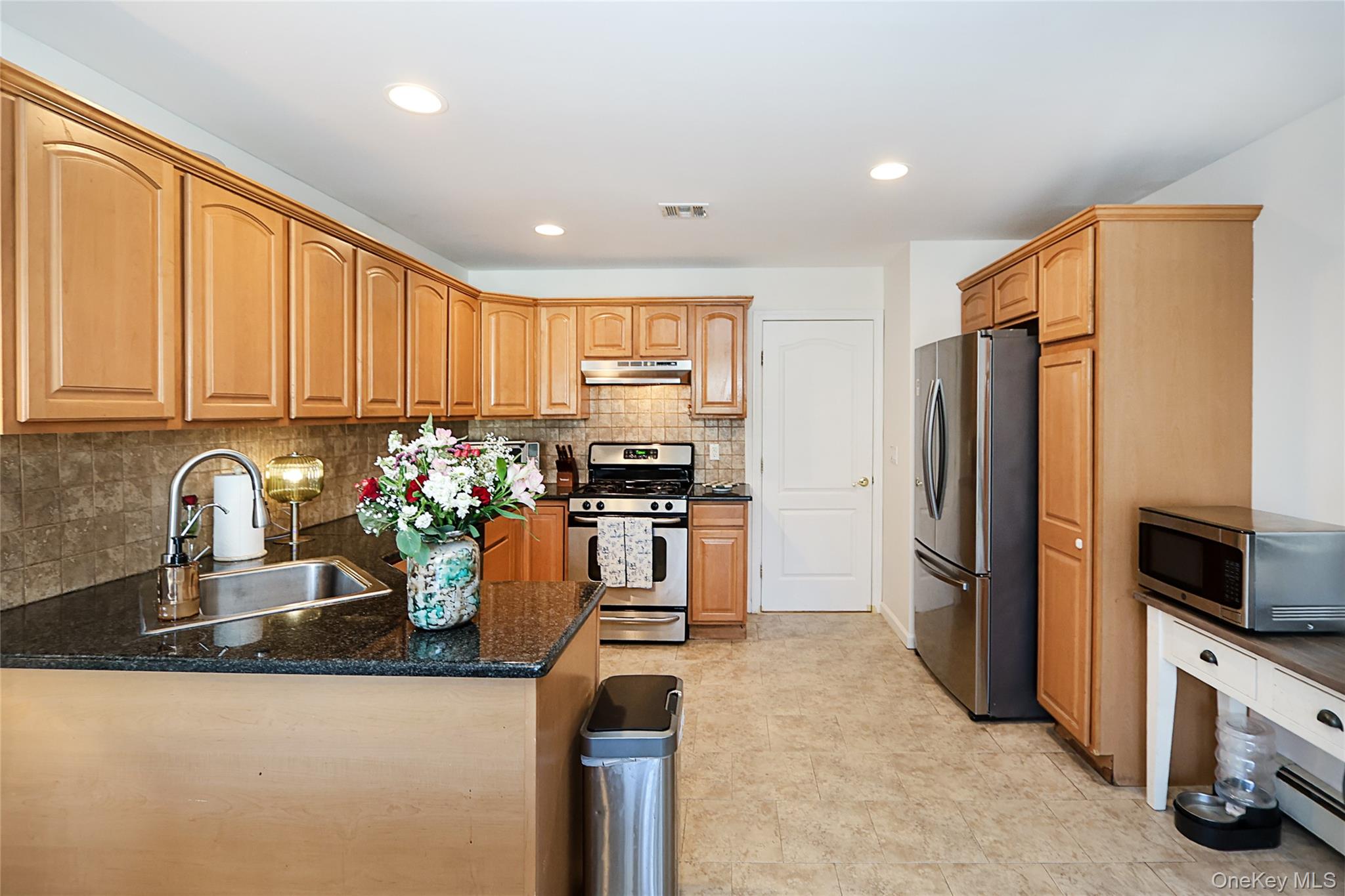 54 Landing Road Glen Cove, NY 11542 - Photo 14 of 24 a kitchen with refrigerator a stove and a sink