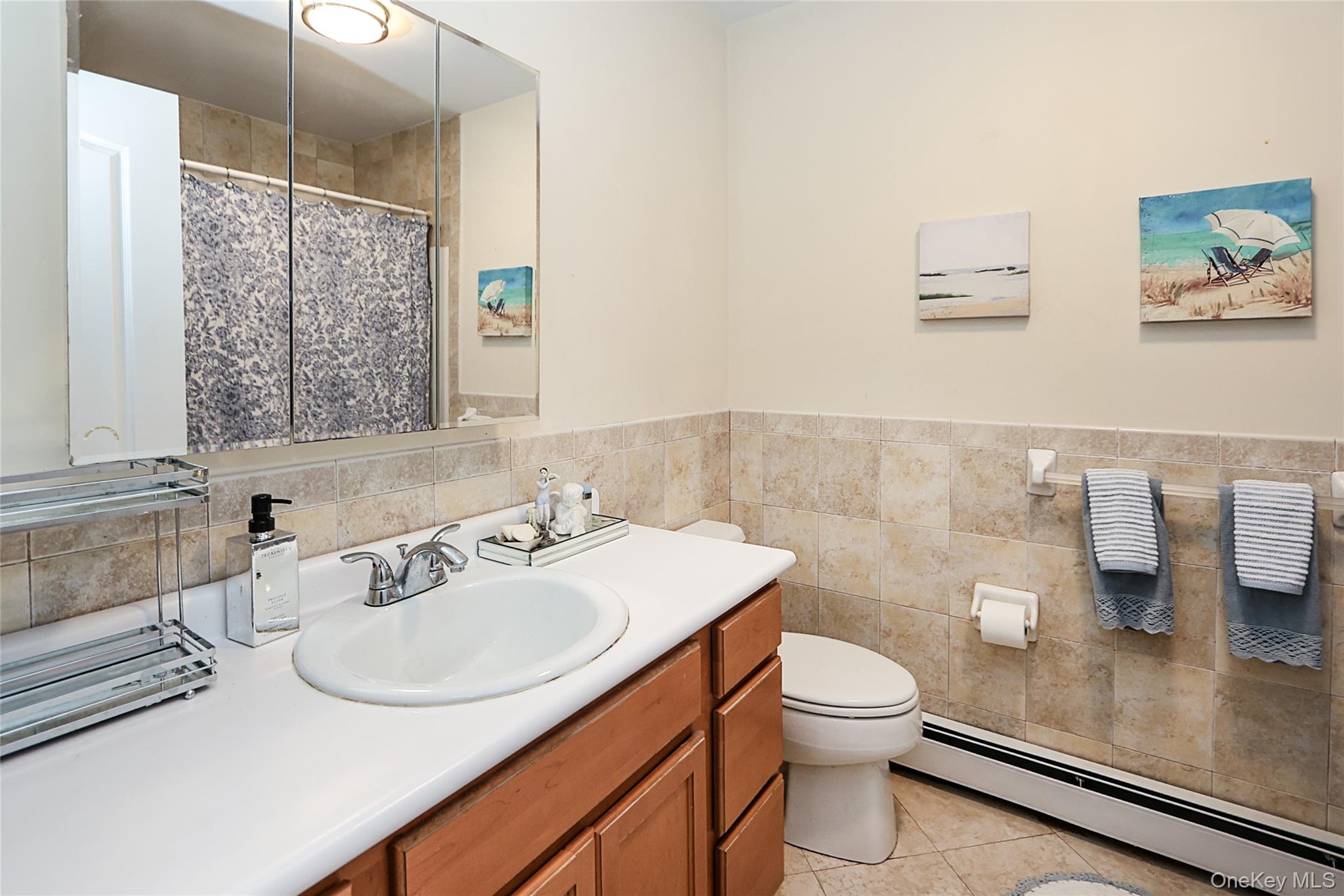 54 Landing Road Glen Cove, NY 11542 - Photo 19 of 24 a bathroom with a sink toilet and a mirror