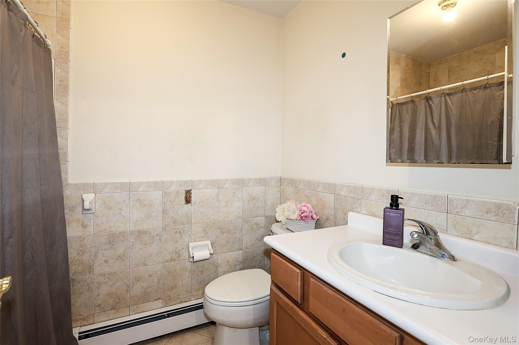 54 Landing Road Glen Cove, NY 11542 - Photo 21 of 24 a bathroom with a sink toilet and a mirror