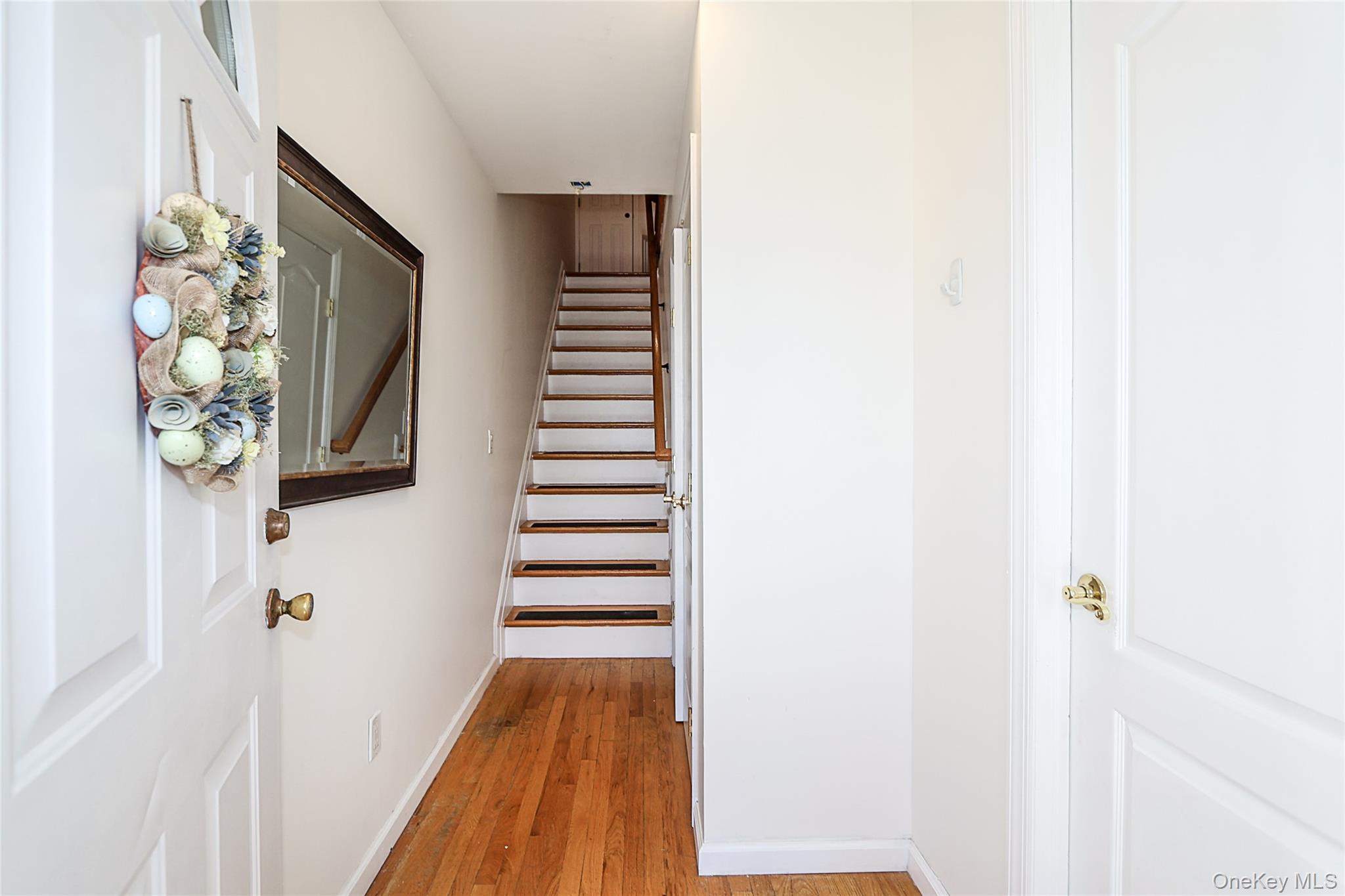54 Landing Road Glen Cove, NY 11542 - Photo 6 of 24 a view of a hallway with wooden floor and entryway