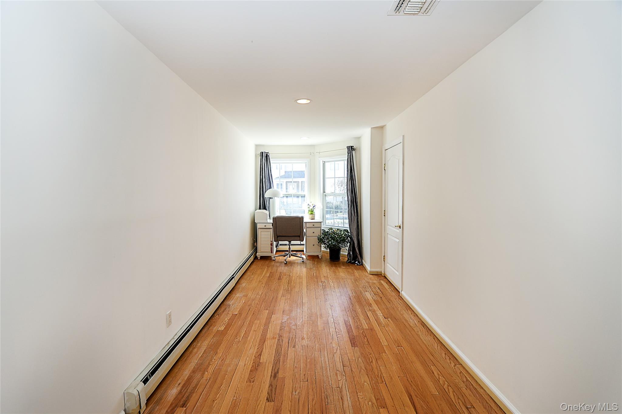 54 Landing Road Glen Cove, NY 11542 - Photo 9 of 24 a view of a room with wooden floor and a window