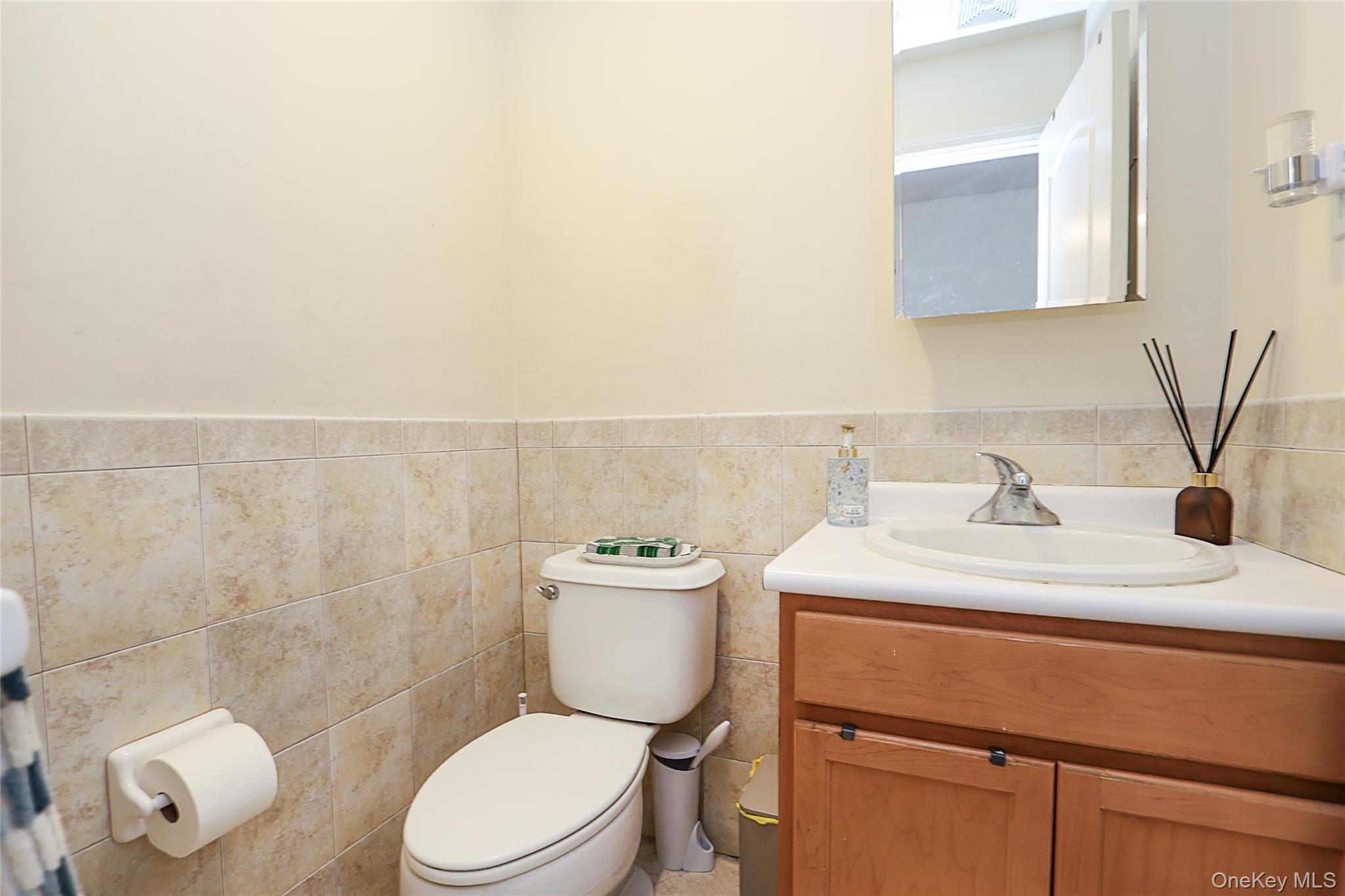 54 Landing Road Glen Cove, NY 11542 - Photo 10 of 24 a bathroom with a sink a toilet and a mirror