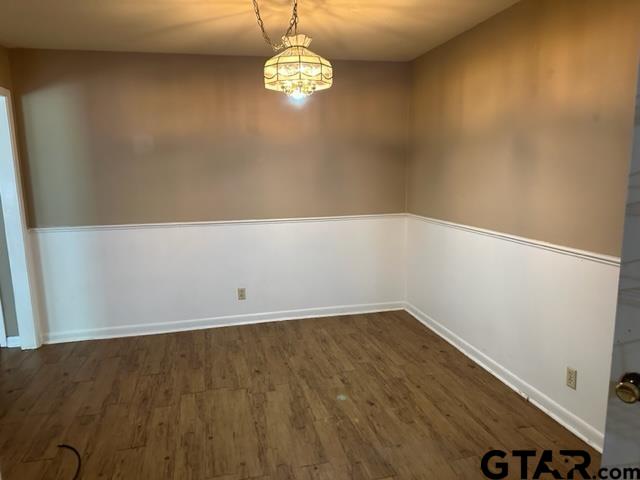 5702 Foxcroft Road Tyler, TX 75703 - Photo 6 of 10 en empty room with wooden floor and window