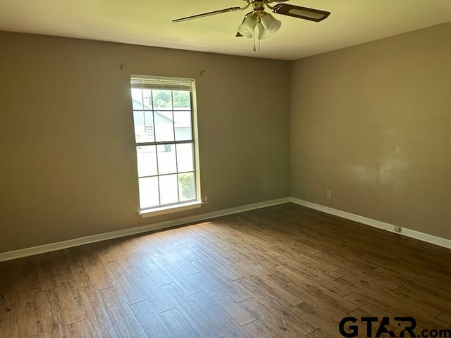 5702 Foxcroft Road Tyler, TX 75703 - Photo 8 of 10 wooden floor in an empty room with a window