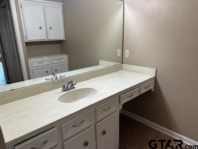5702 Foxcroft Road Tyler, TX 75703 - Photo 9 of 10 a bathroom with a sink and a mirror