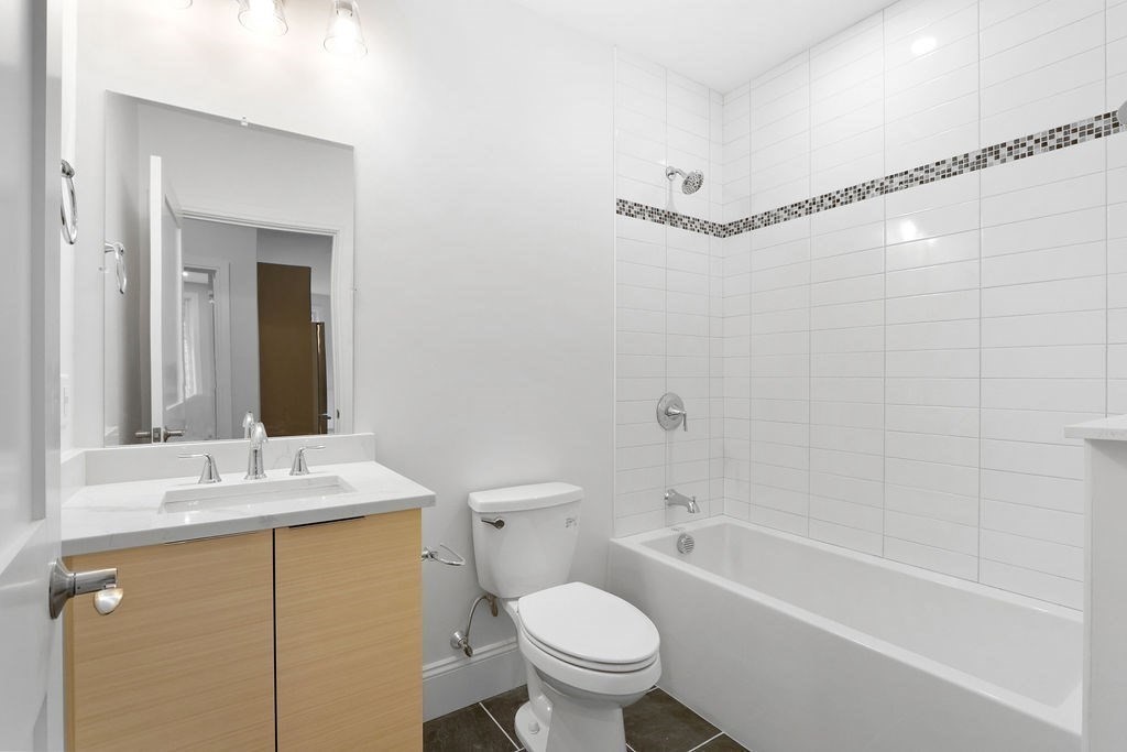 21 Glen Road, Unit 10 Boston, MA 02130 - Photo 9 of 11 a bathroom with a sink toilet and shower