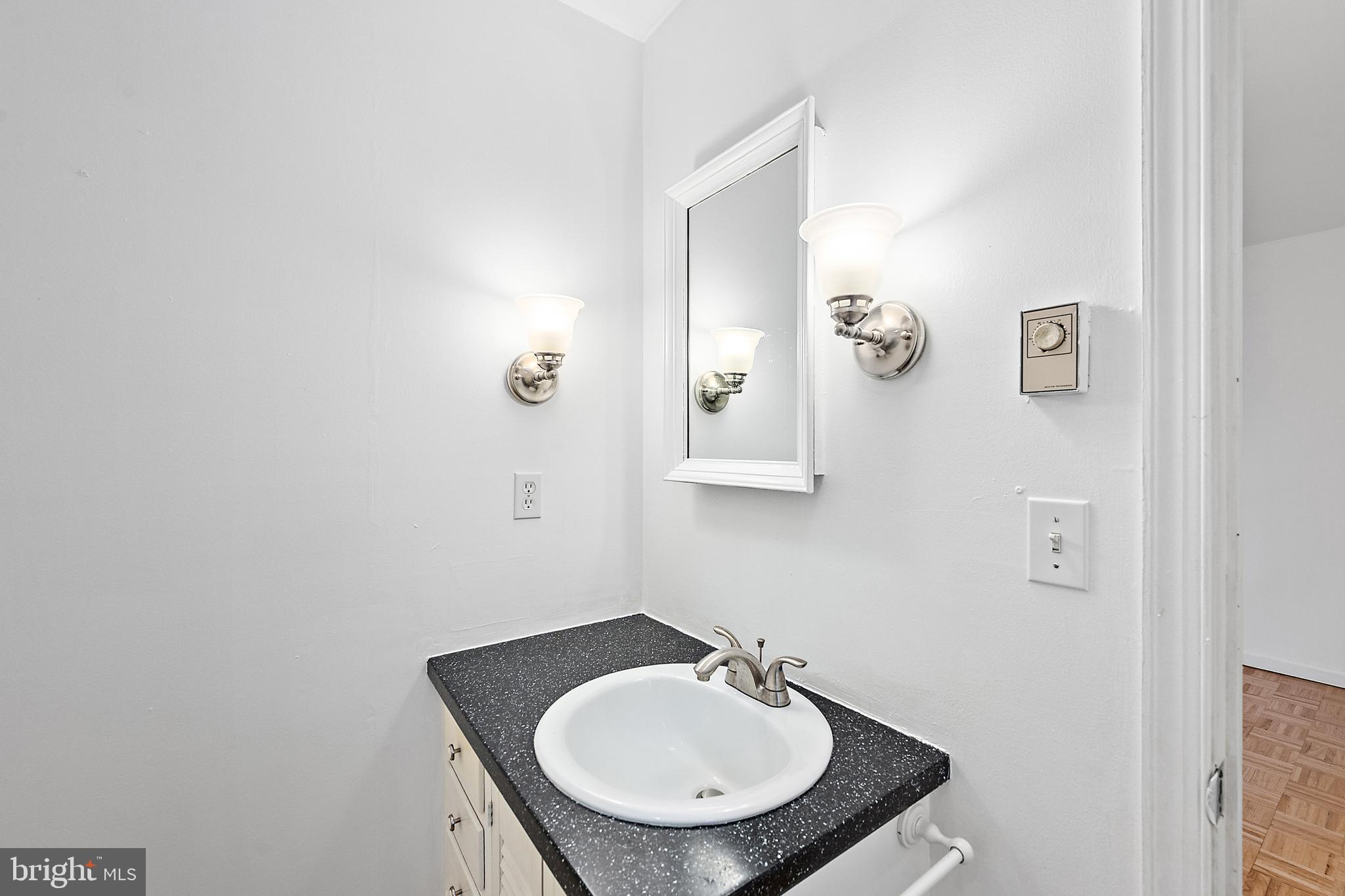 6181 Rockawalkin Road Salisbury, MD 21801 - Photo 49 of 65 a bathroom with a sink and a mirror