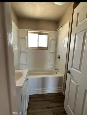 a bathroom with a bathtub and a sink