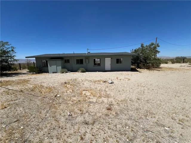 a view of wooden fence under a large tree