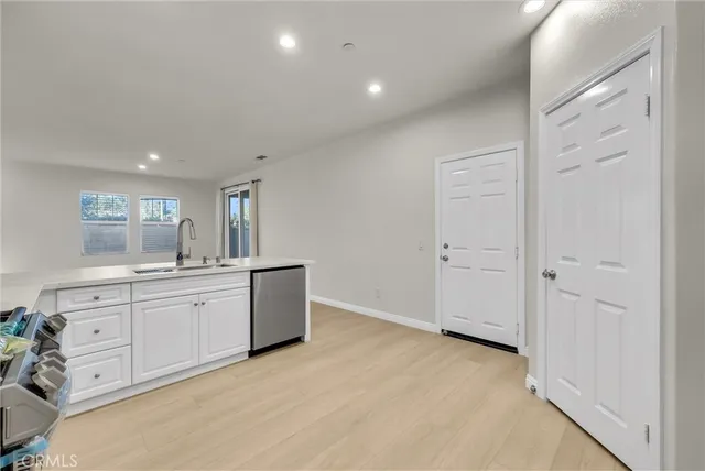 an empty room with closet and windows