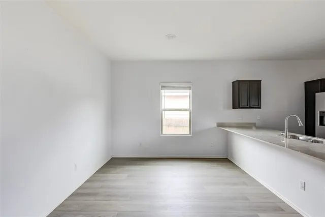 a kitchen with a sink appliances and cabinets