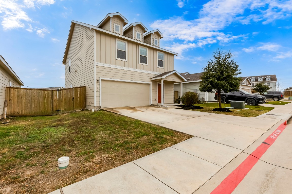 772 Circle Way Jarrell, TX 76537 - Photo 2 of 35 Traditional home with board and batten siding, concrete driveway, and an attached garage
