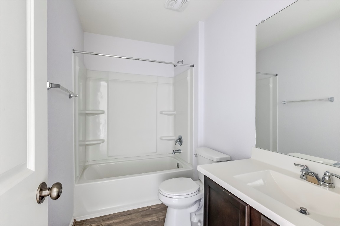 772 Circle Way Jarrell, TX 76537 - Photo 26 of 35 Full bath with vanity, tub / shower combination, and dark wood-style flooring