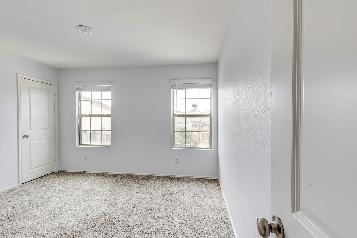 772 Circle Way Jarrell, TX 76537 - Photo 27 of 35 Carpeted empty room with plenty of natural light