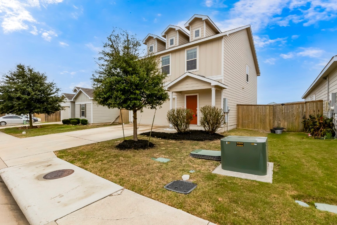 772 Circle Way Jarrell, TX 76537 - Photo 3 of 35 View of front of house with concrete driveway, board and batten siding, and a garage