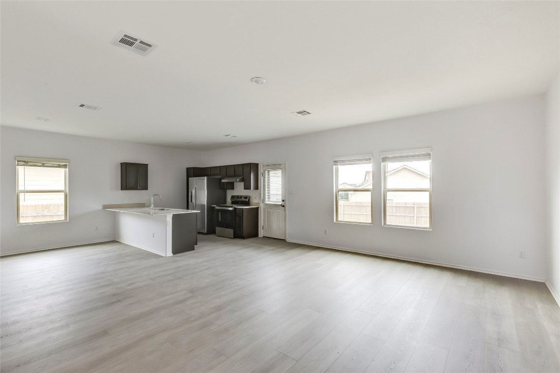 772 Circle Way Jarrell, TX 76537 - Photo 6 of 35 Unfurnished living room with baseboards and light wood-style floors