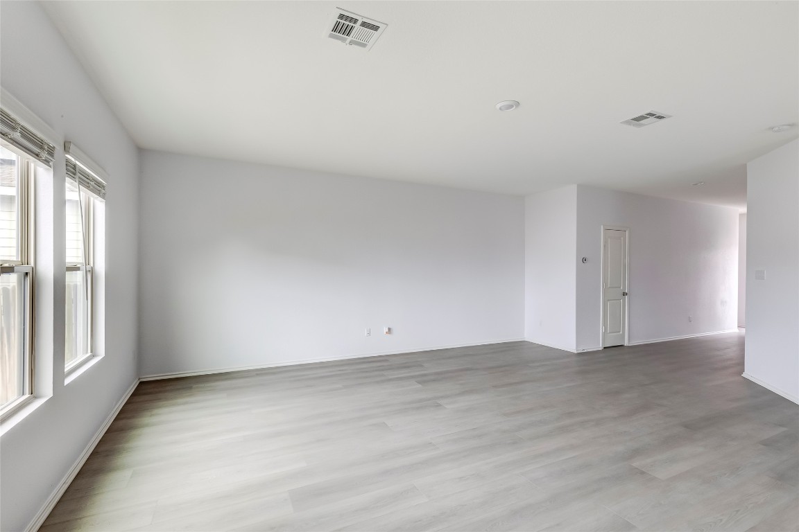 772 Circle Way Jarrell, TX 76537 - Photo 7 of 35 Unfurnished room with light wood-style floors and baseboards