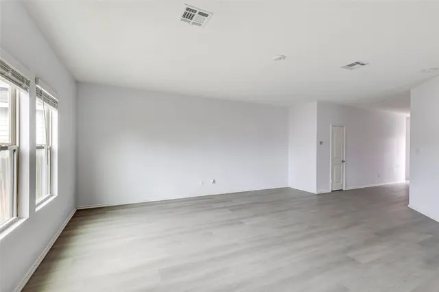 a view of a kitchen with a sink and dishwasher a refrigerator with wooden floor