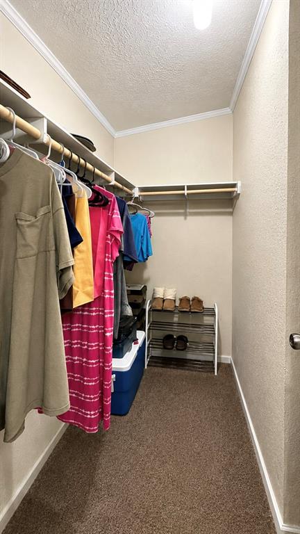 741 Waterfront Row Quitman, TX 75783 - Photo 19 of 40 a view of walk in closet with clothes