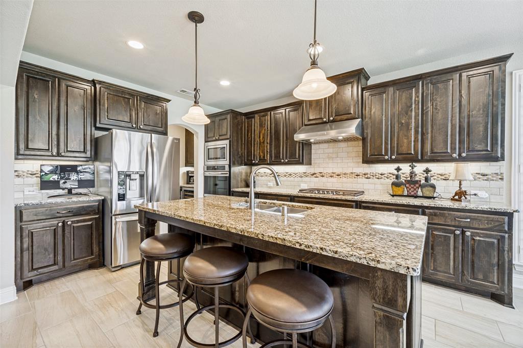 3036 Avondale The Colony, TX 75056 - Photo 14 of 40 The kitchen is the heart of the home, featuring a large island, beautiful finishes, and plenty of space to cook, gather, and entertain.