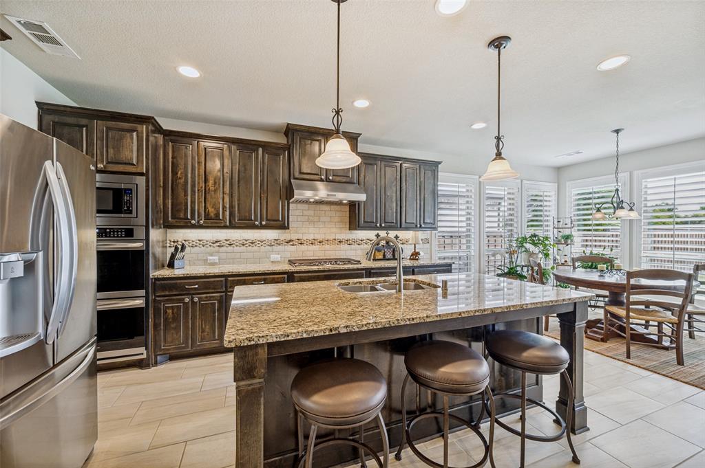 3036 Avondale The Colony, TX 75056 - Photo 15 of 40 The kitchen opens up beautifully to the breakfast area, making it easy to stay connected whether you're cooking, dining, or just spending time together.