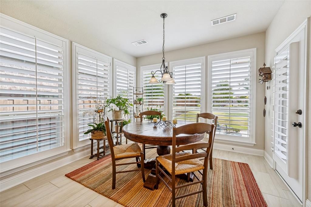 3036 Avondale The Colony, TX 75056 - Photo 18 of 40 The breakfast nook is filled with natural light, creating the perfect spot to start your day with coffee and enjoy the view of the backyard.