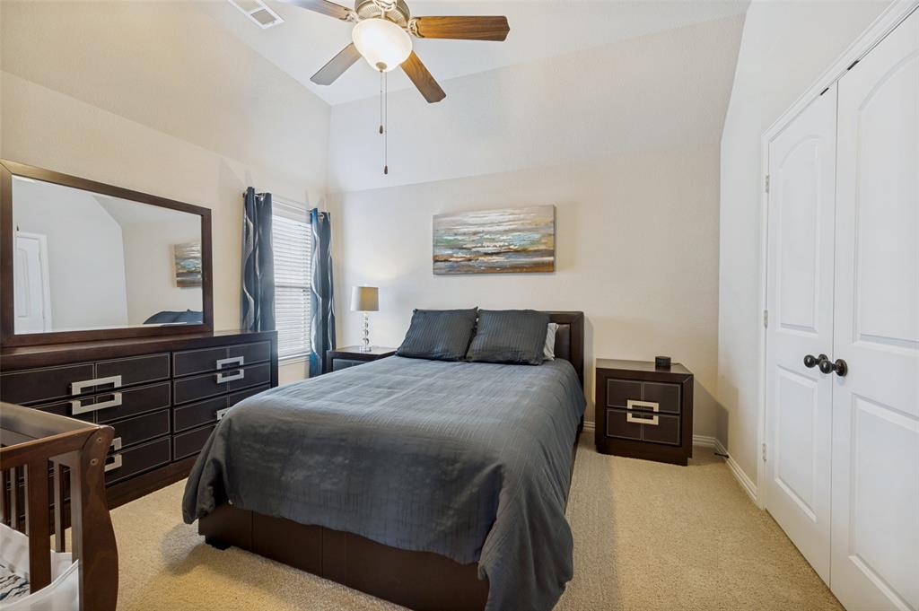 3036 Avondale The Colony, TX 75056 - Photo 28 of 40 Spacious secondary bedroom featuring vaulted ceilings, soft natural light, and a comfortable, inviting layout.