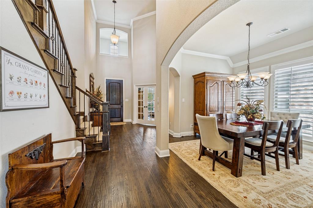 3036 Avondale The Colony, TX 75056 - Photo 3 of 40 Walking in, you’re greeted by beautiful hardwood floors, high ceilings, and an open, airy entry that leads into a cozy dining area—perfect for gathering with family and friends.