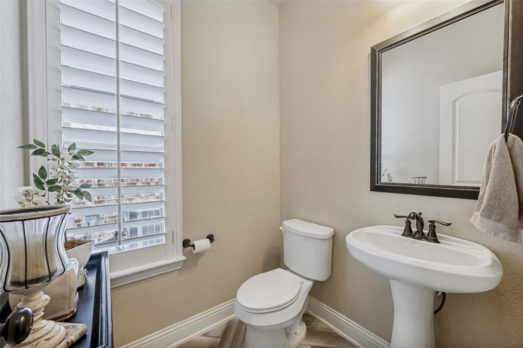 3036 Avondale The Colony, TX 75056 - Photo 6 of 40 This light-filled powder bath offers a clean, refreshed feel and is perfectly situated for guests.