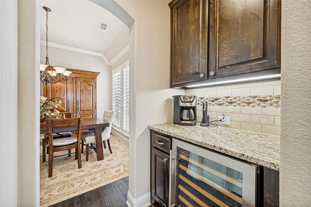 3036 Avondale The Colony, TX 75056 - Photo 9 of 40 A convenient beverage nook with wine fridge, perfect for hosting or enjoying a relaxing evening at home.