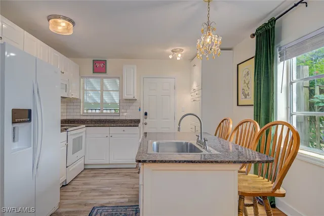 a kitchen with sink cabinets and window