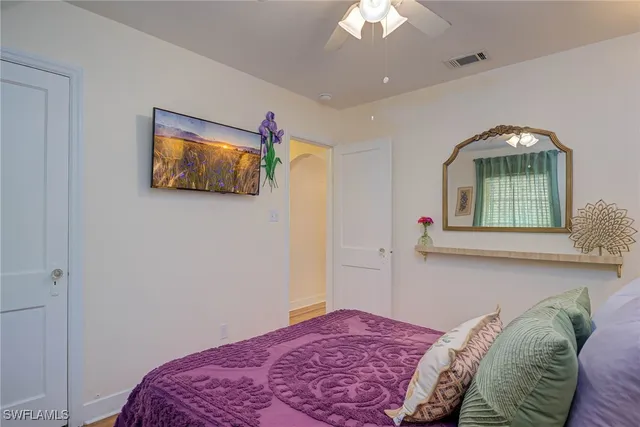 a bedroom with a bed and a painting on the wall