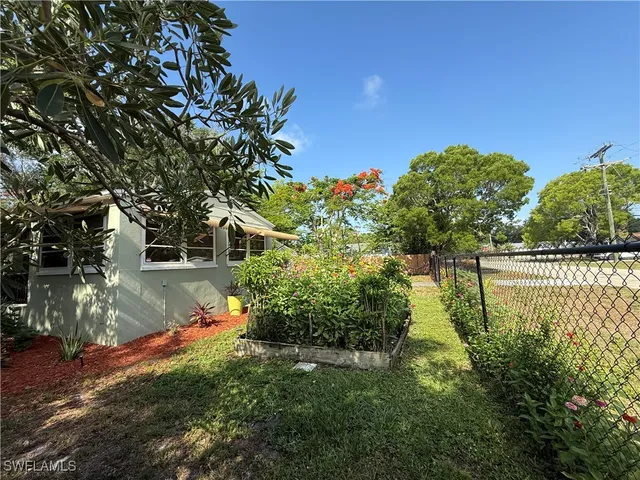 a backyard of a house with lots of green space and lake view