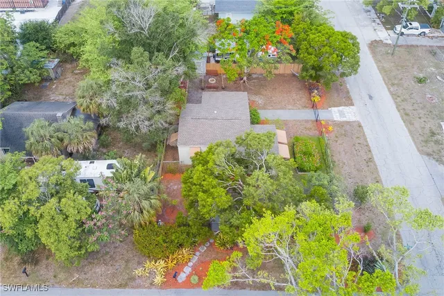 an aerial view of a house with a yard and garden