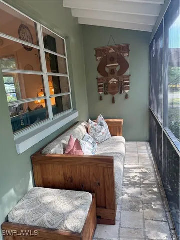 a view of balcony with furniture and window
