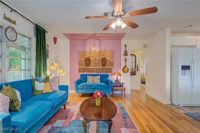 a living room with furniture and a chandelier