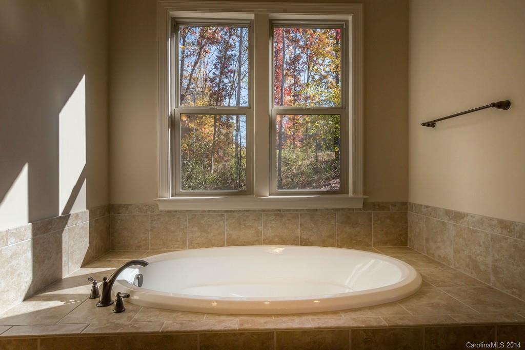 1600 Buckland Court Indian Land, SC 29707 - Photo 16 of 24 a bath tub sitting in a bathroom next to a window