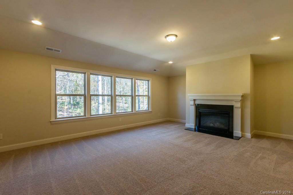 1600 Buckland Court Indian Land, SC 29707 - Photo 20 of 24 an empty room with a fireplace and windows