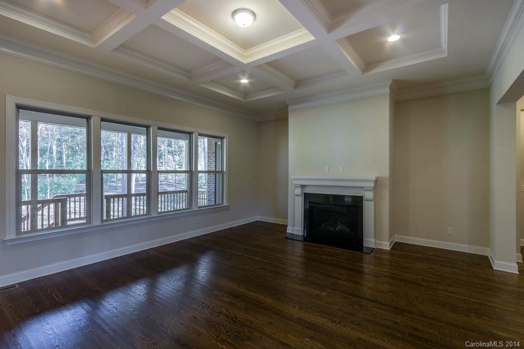 1600 Buckland Court Indian Land, SC 29707 - Photo 8 of 24 an empty room with wooden floor fireplace and windows