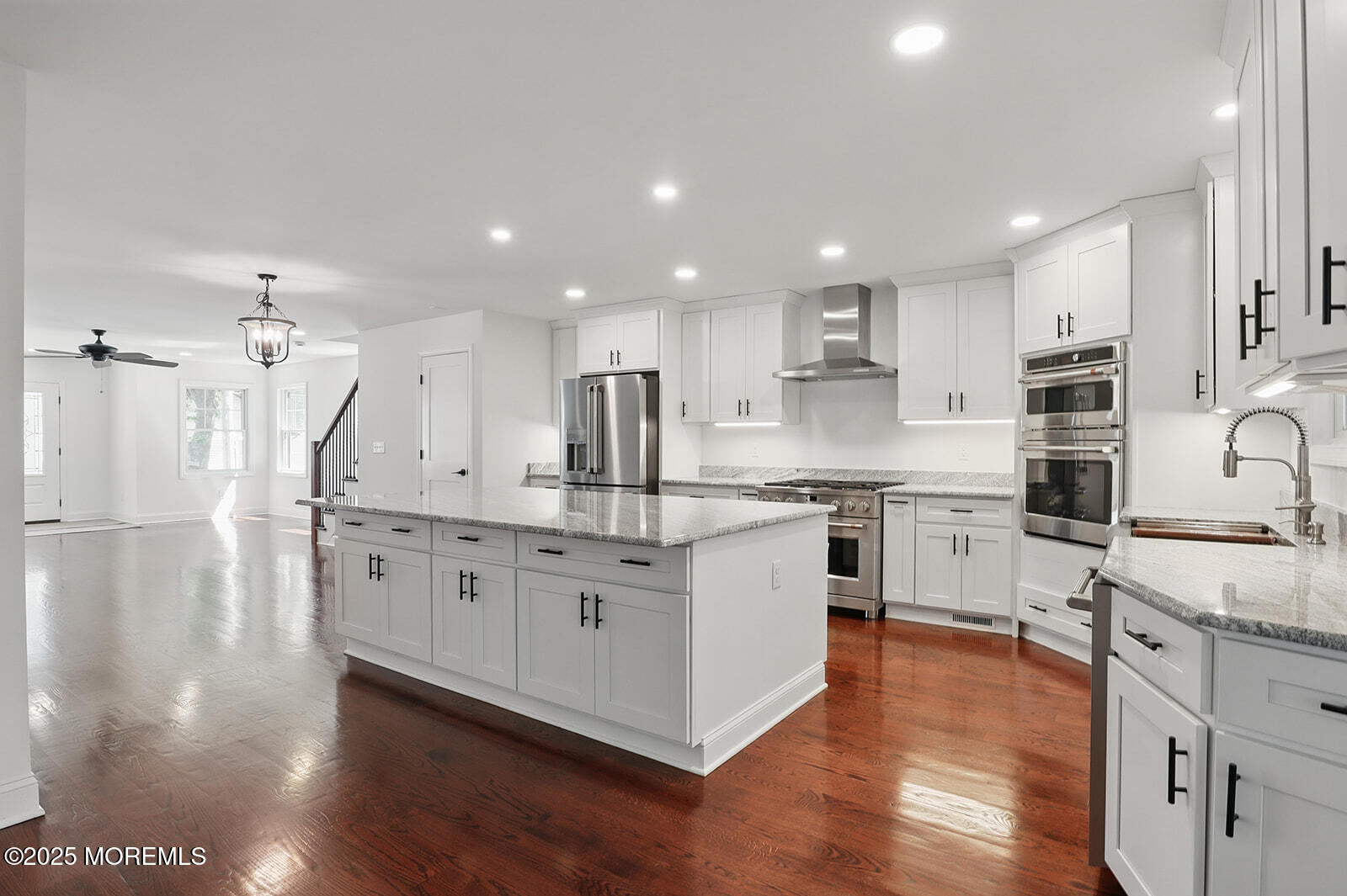 18 Neptune Place North Middletown, NJ 07748 - Photo 11 of 49 a large kitchen with stainless steel appliances granite countertop a large center island a sink a stove and a refrigerator