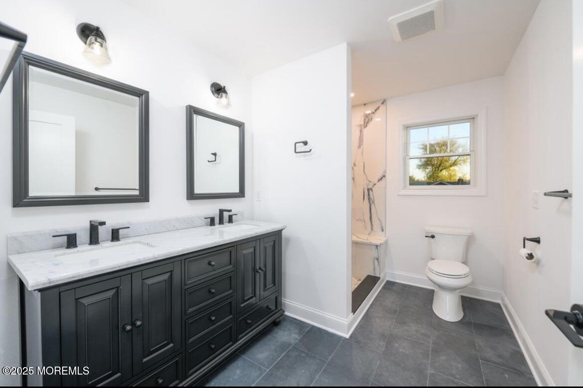18 Neptune Place North Middletown, NJ 07748 - Photo 16 of 49 a bathroom with a toilet sink and mirror
