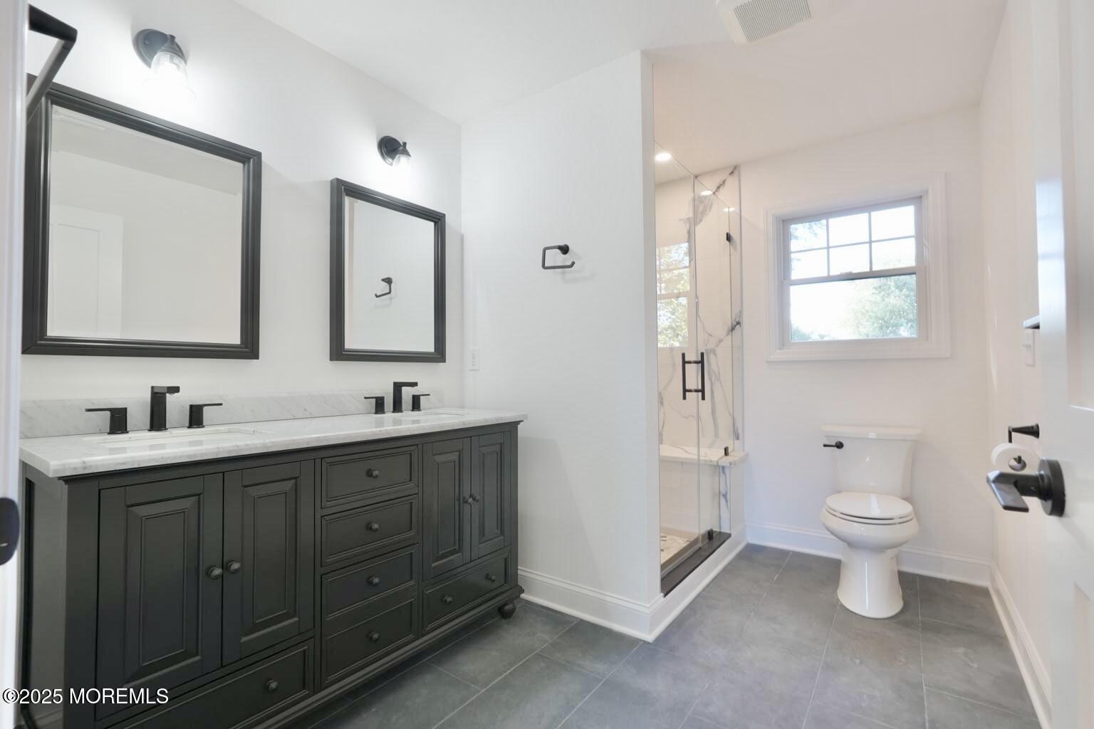 18 Neptune Place North Middletown, NJ 07748 - Photo 17 of 49 a bathroom with a toilet sink double vanity and mirror