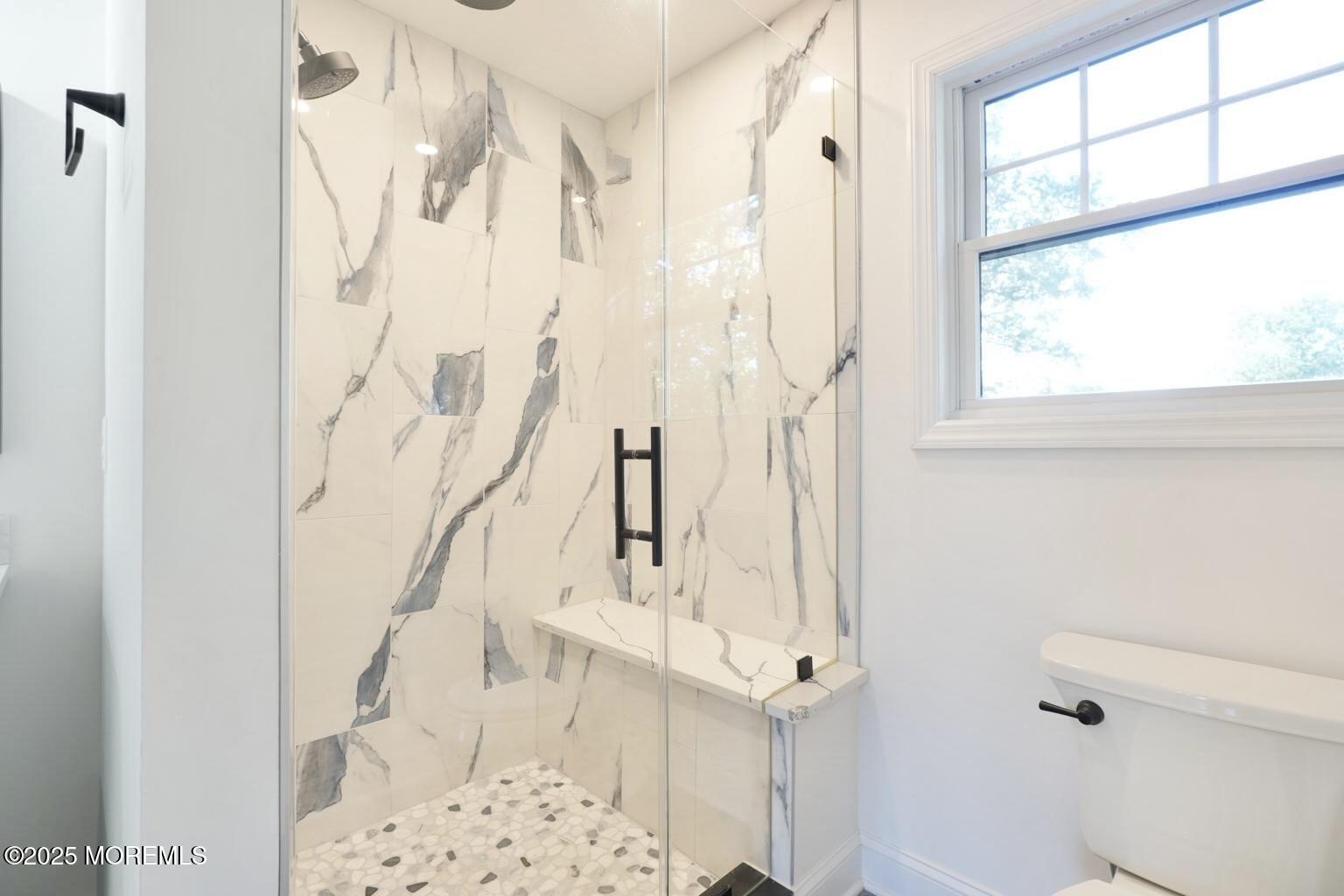 18 Neptune Place North Middletown, NJ 07748 - Photo 19 of 49 a bathroom with a shower curtain and a window